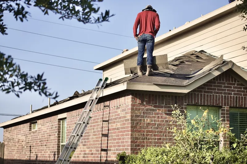 Professional roofer working on a residential roof in Mud Island